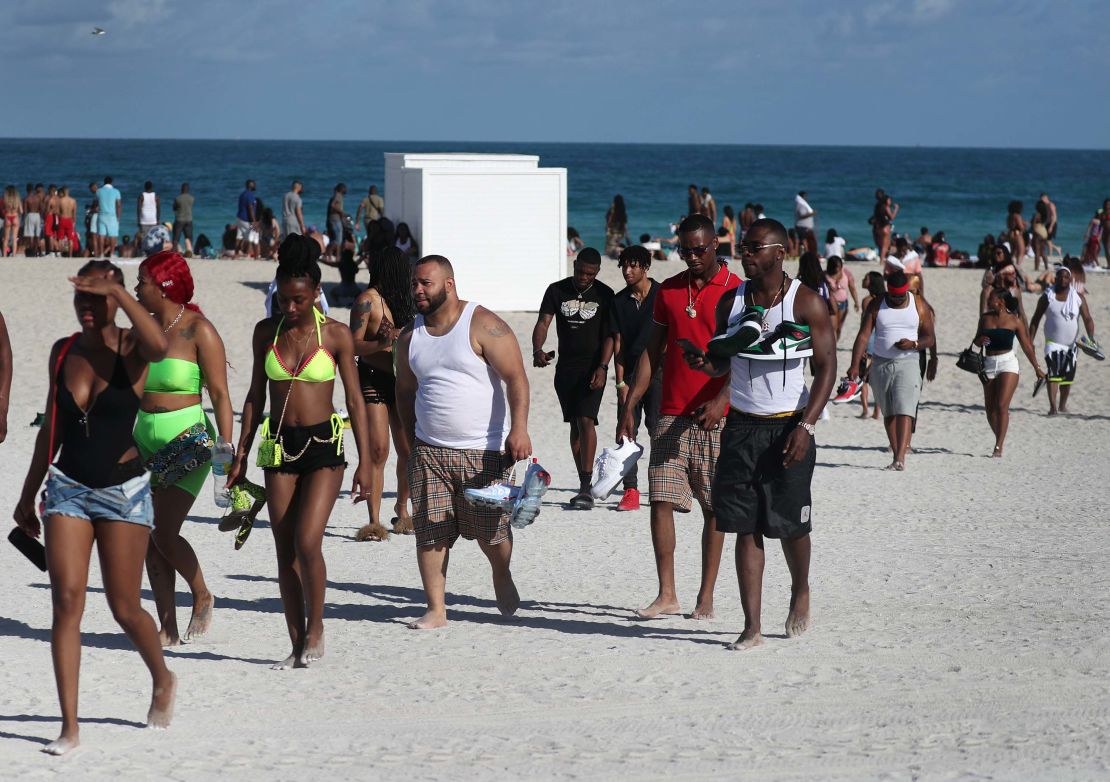 Beachgoers leave South Beach on Sunday. 