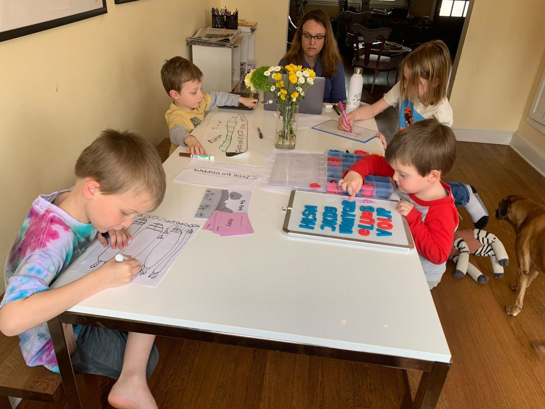 Nicole Coomber working at her home in Washington D.C. with her four boys, ages 4 to 9. 