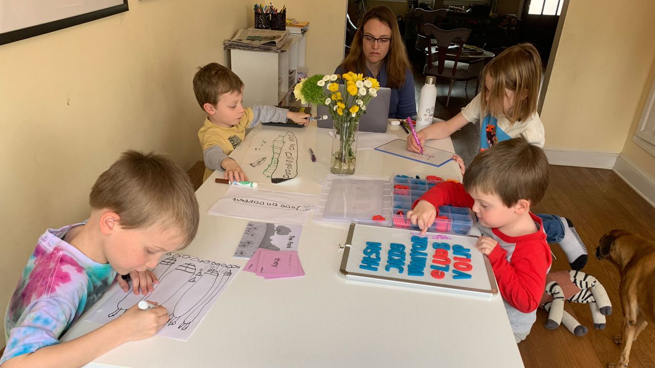 Nicole Coomber working at her home in Washington D.C. with her four boys, ages 4 to 9. 