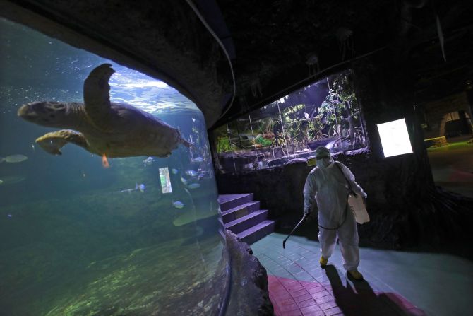 A Sea World employee sprays disinfectant in Jakarta, Indonesia, on March 14, 2020.