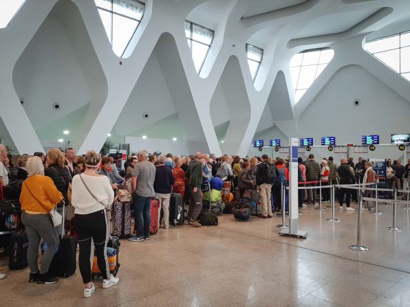 Passengers wait for their flights at Marrakesh Airport in Morocco on March 15, 2020.