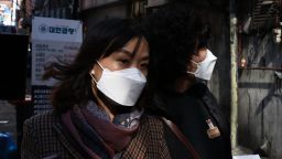 SEOUL, SOUTH KOREA - MARCH 16: People wear masks to protect themself from the coronavirus (COVID-19) and walk along the street on March 16, 2020 in Seoul, South Korea. According to the Korea Center for Disease Control and Prevention on Friday, 74 new cases were reported. The total number of infections in the nation tallies at 8,236. (Photo by Chung Sung-Jun/Getty Images)