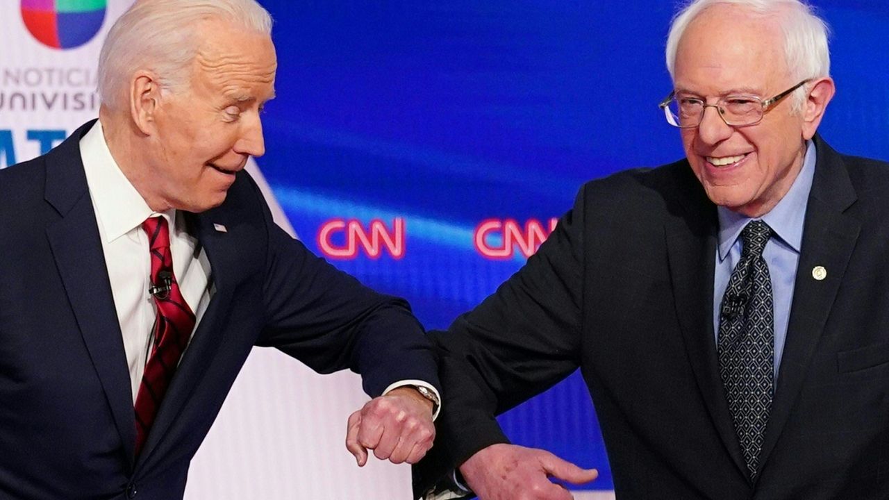 TOPSHOT - Democratic presidential hopefuls former US vice president Joe Biden (L) and Senator Bernie Sanders greet each other with a safe elbow bump before the start of the 11th Democratic Party 2020 presidential debate in a CNN Washington Bureau studio in Washington, DC on March 15, 2020. (Photo by Mandel NGAN / AFP) (Photo by MANDEL NGAN/AFP via Getty Images)