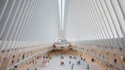 The Oculus at the World Trade Center's transportation hub is sparsely occupied, Monday, March 16, 2020 in New York. Millions of Americans have begun their work weeks holed up at home, as the coronavirus pandemic means the entire nation's daily routine has shifted in ways never before seen in U.S. history. (AP Photo/Mark Lennihan)
