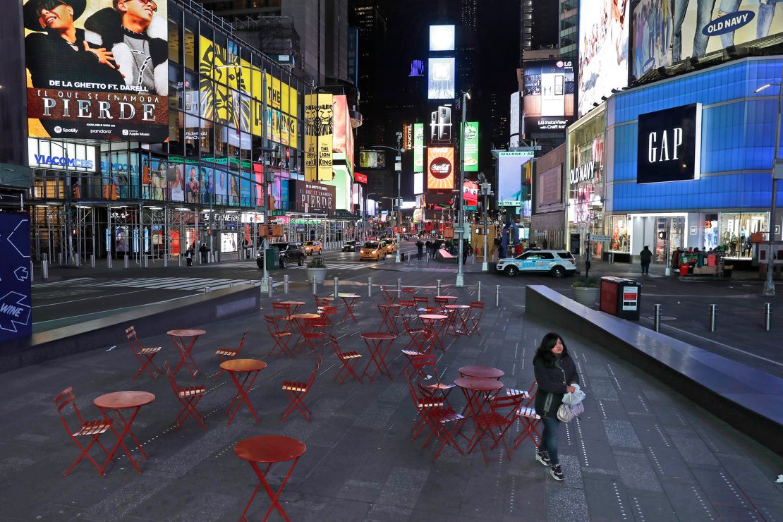 A woman walks through a lightly trafficked Times Square in New York on March 16.