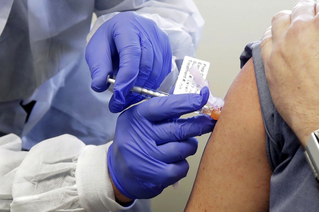 A patient receives a shot in the first-stage safety study clinical trial of a potential vaccine for Covid-19 on March 16, 2020, at the Kaiser Permanente Washington Health Research Institute in Seattle. 