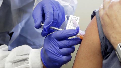 A patient receives a shot in the first-stage safety study clinical trial of a potential vaccine for Covid-19 on March 16, 2020, at the Kaiser Permanente Washington Health Research Institute in Seattle. 