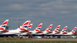 This picture shows British Airways planes grounded at Heathrow's airport terminal 5, in west London, on March 16, 2020. - IAG, the owner of British Airways and Spanish carrier Iberia, said Monday it would slash the group's flight capacity by 75 percent during April and May owing to the coronavirus outbreak. "For April and May, the Group plans to reduce capacity by at least 75 percent compared to the same period in 2019," it said in a statement. (Photo by Adrian Dennis/AFP/Getty Images)