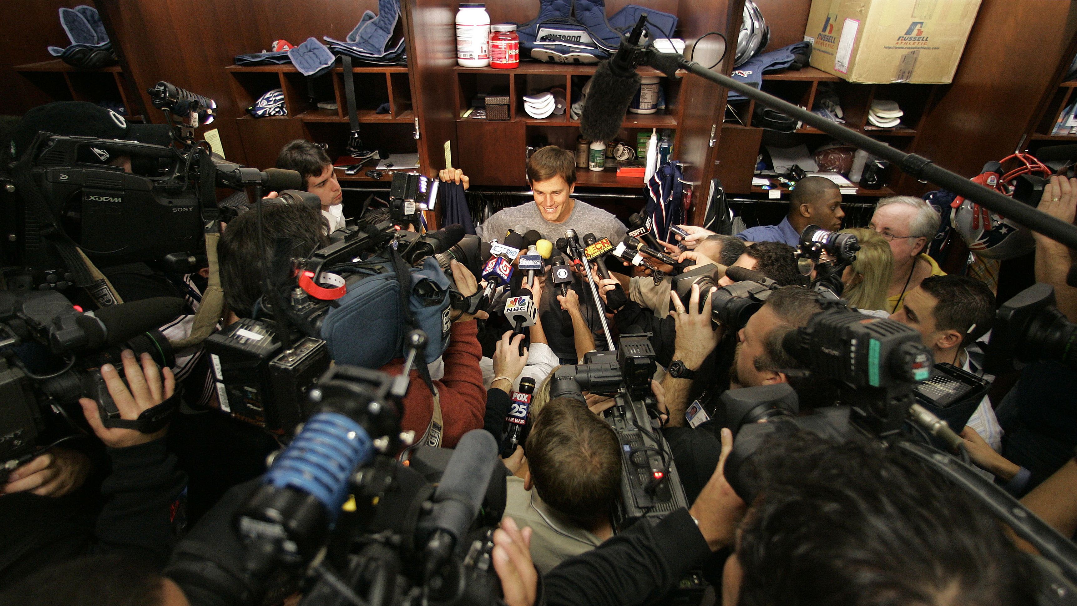Brady is surrounded by the media in 2007. The Patriots went undefeated in the regular season but lost to the New York Giants in the Super Bowl.