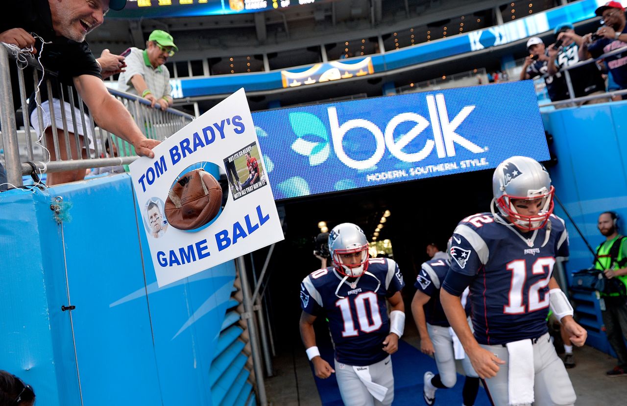 An opposing fan taunts Brady as he takes the field in August 2015. Brady was eventually suspended four games over the "Deflategate" controversy, which involved allegations that the Patriots purposely deflated balls to gain an advantage on offense in an AFC Championship game.