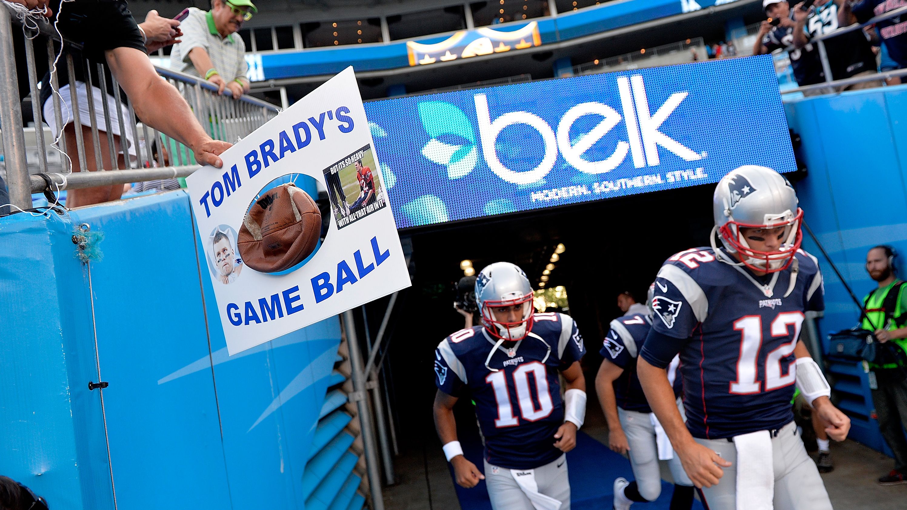 An opposing fan taunts Brady as he takes the field in August 2015. Brady was eventually suspended four games over the "Deflategate" controversy, which involved allegations that the Patriots purposely deflated balls to gain an advantage on offense in an AFC Championship game.