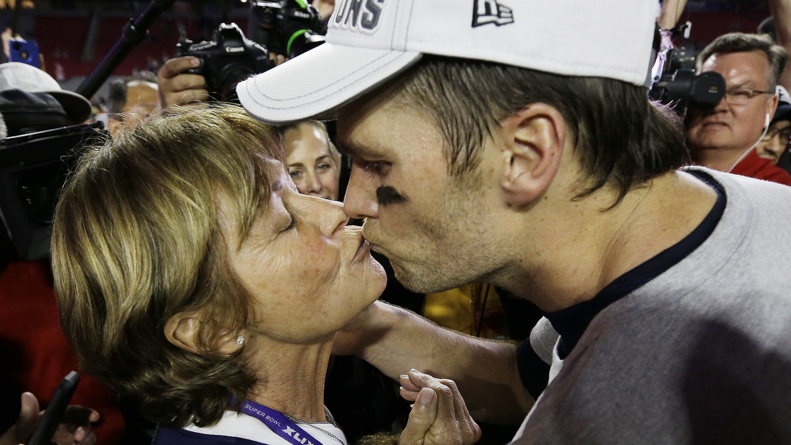 Brady kisses his mother, Galynn, after the Patriots defeated Seattle for their fourth Super Bowl title in February 2015.