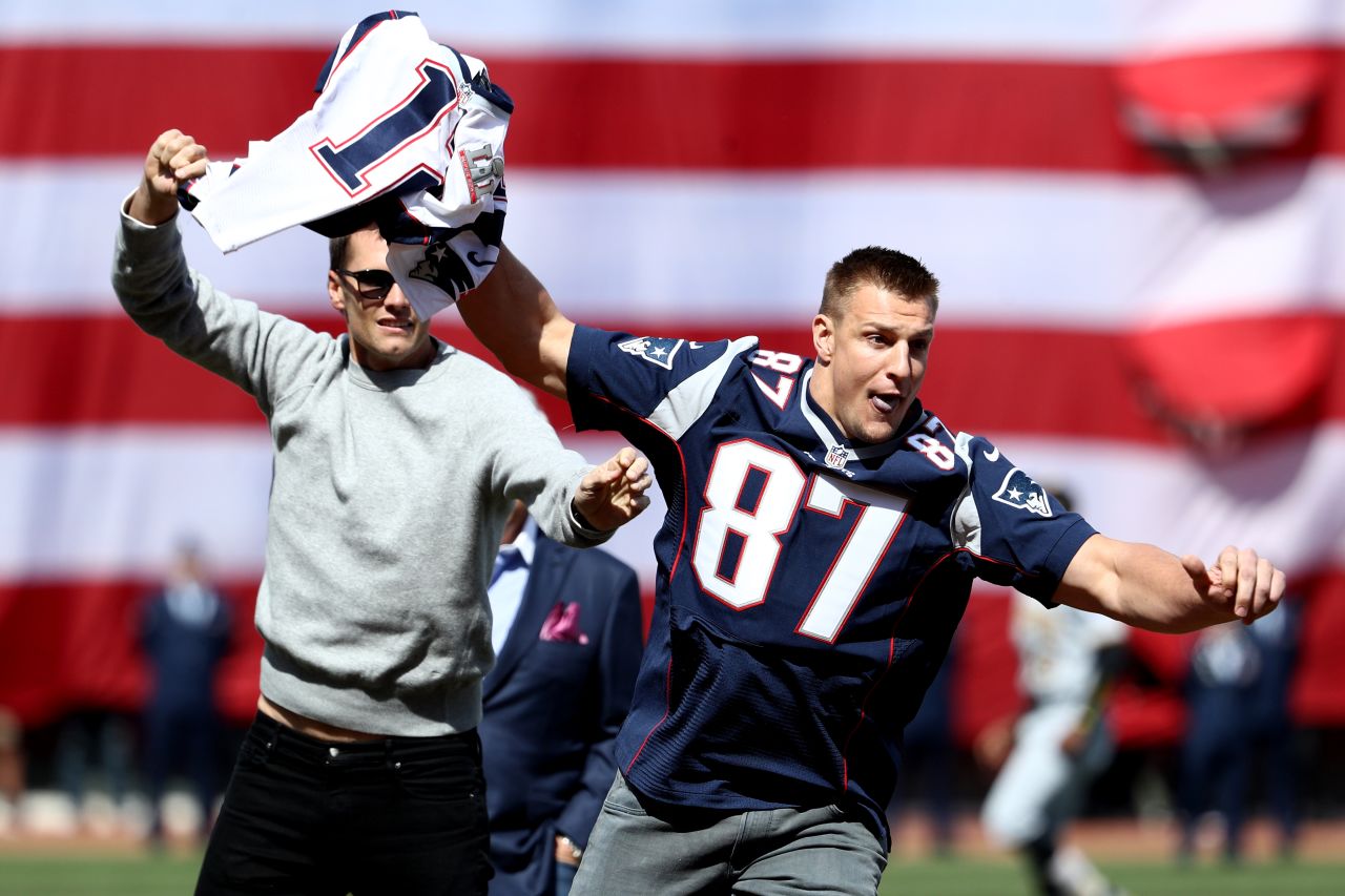 Teammate Rob Gronkowski playfully steals Brady's jersey before a Boston Red Sox baseball game in April 2017. Brady had just had his Super Bowl jersey returned by authorities after it had been stolen from the locker room.