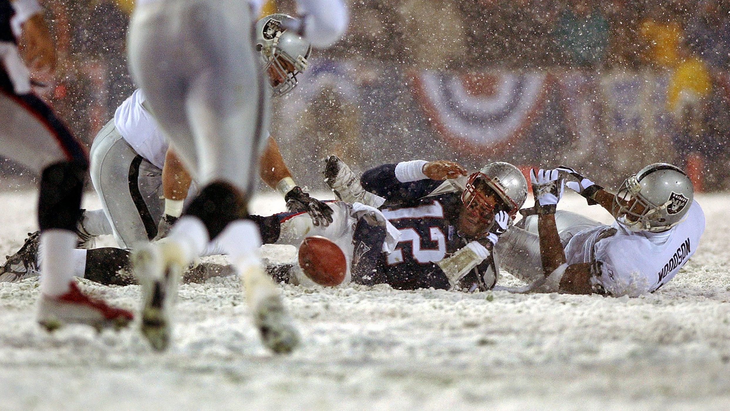 Brady loses the ball after being hit by Oakland's Charles Woodson during an NFL playoff game in January 2002. The Patriots got the ball back and went on to win the game, but the controversial play was heavily debated in the offseason. The "tuck rule" was eventually repealed in 2013.