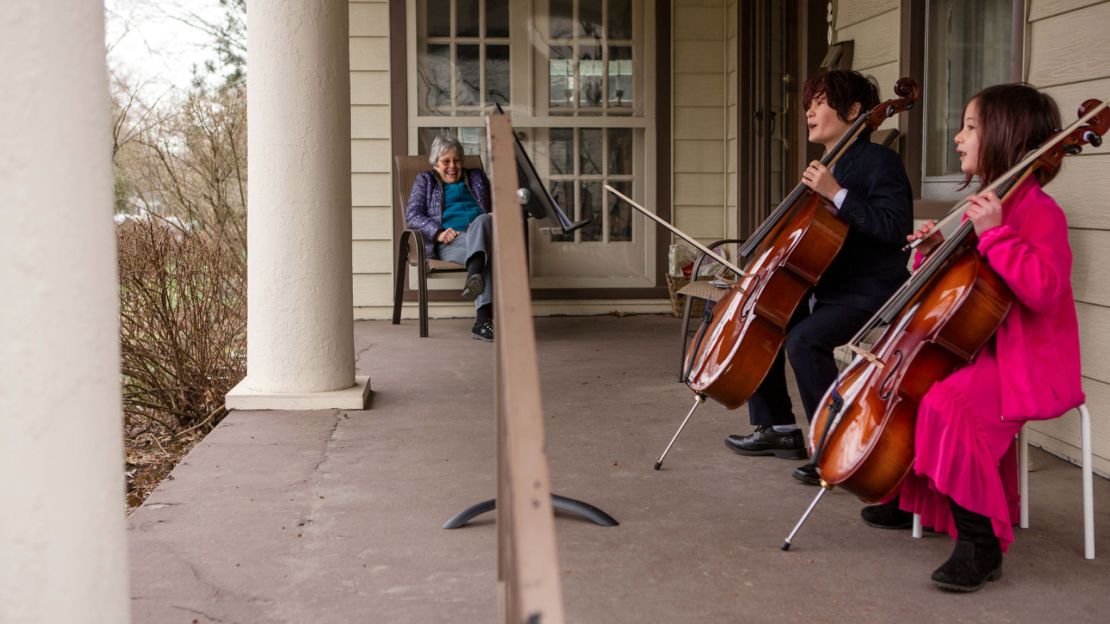 Taran and Calliope Tien playing the cello for Helena Schlam. 