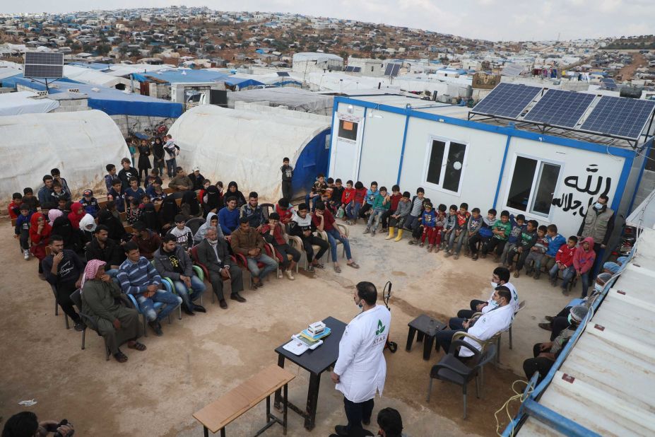 Displaced families near Atme, Syria, attend a workshop aimed at spreading awareness about the coronavirus.