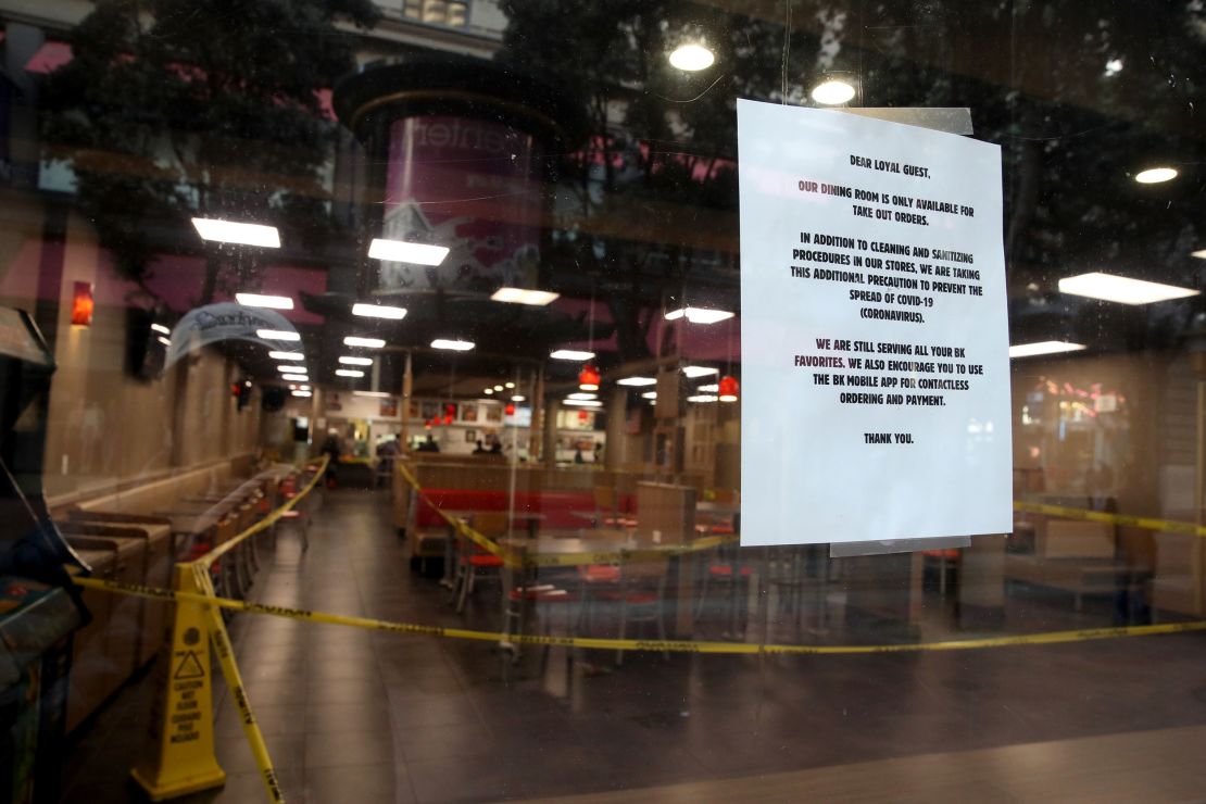 Stores and restaurants posted signs outside informing customers that they are closed.