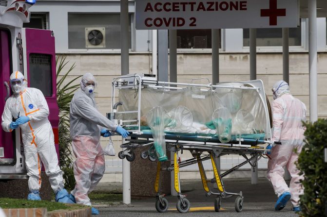 A patient in a biocontainment unit is carried on a stretcher in Rome on March 17, 2020.