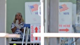 A polling place worker in gloves as she tends to a reception table during the Florida primary election on March 17, which went forward amid coronavirus concerns.