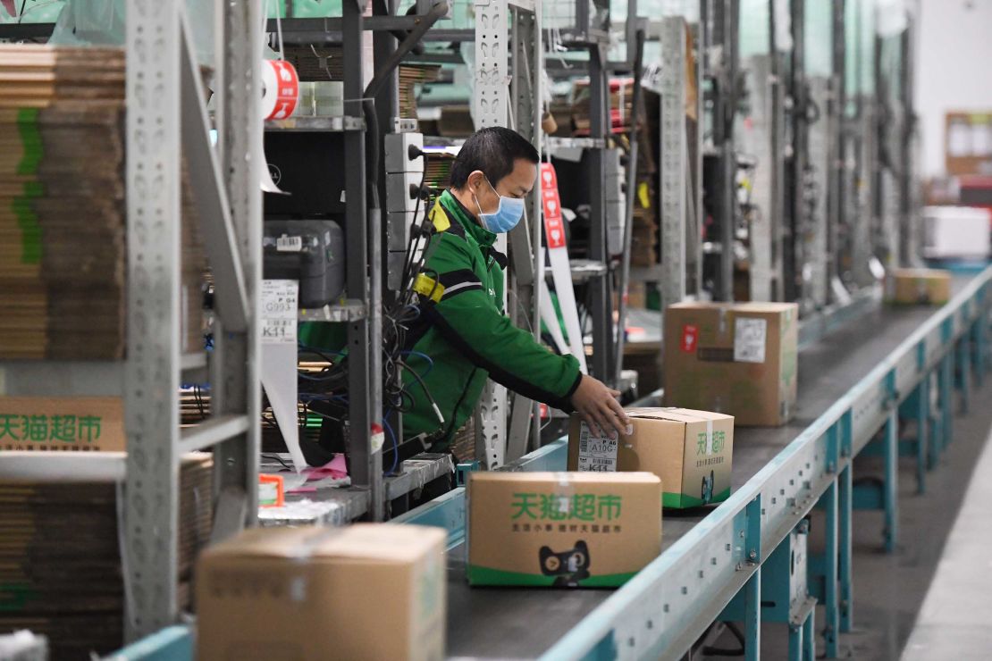  A worker packs goods at a logistics center in Beijing, capital of China, March 12, 2020.