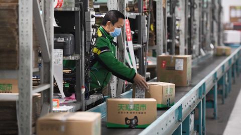  A worker packs goods at a logistics center in Beijing, capital of China, March 12, 2020.