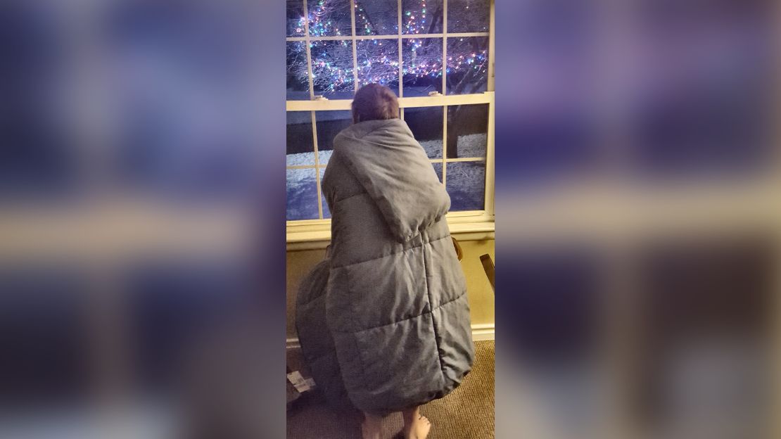 Mike and Holly Griffin's son looks out their window at the Christmas lights now up in their yard.