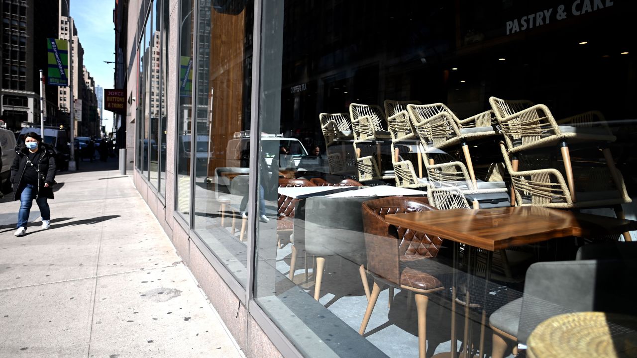 Chairs are stacked in a closed Cafe in Manhattan on March 16, 2020 in New York City. - Stocks tumbled on March 16, 2020 despite emergency central bank measures to prop up the virus-battered global economy, as countries across Europe started the week in lockdown and major US cities shut bars and restaurants. The virus has upended society around the planet, with governments imposing restrictions rarely seen outside wartime, including the closing of borders, home quarantine orders and the scrapping of public events including major sporting fixtures. (Photo by Johannes Eisele/AFP/Getty Images)
