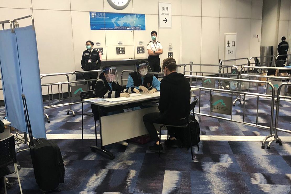 Quarantine officers interview Will Ripley on arrival at Hong Kong International Airport on March 15.