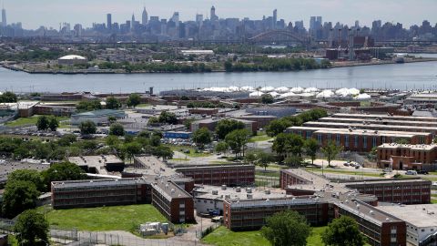 In this June 20, 2014, file photo, the Rikers Island jail complex stands in New York with the Manhattan skyline in the background.