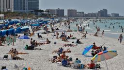 Visitors enjoy Clearwater Beach, Wednesday, March 18, 2020, in Clearwater Beach, Fla. Beachgoers are trying to keep a safe distance from each other by keeping a space of 6 to 10 feet (2 to 3 meters) between family groups to help protect from the spread of the coronavirus. (AP Photo/Chris O'Meara)