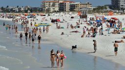 Visitors enjoy Clearwater Beach, Wednesday, March 18, 2020, in Clearwater Beach, Fla. Beach goers are keeping a safe distance from each other to help protect from the spread of the Coronavirus. (AP Photo/Chris O'Meara)