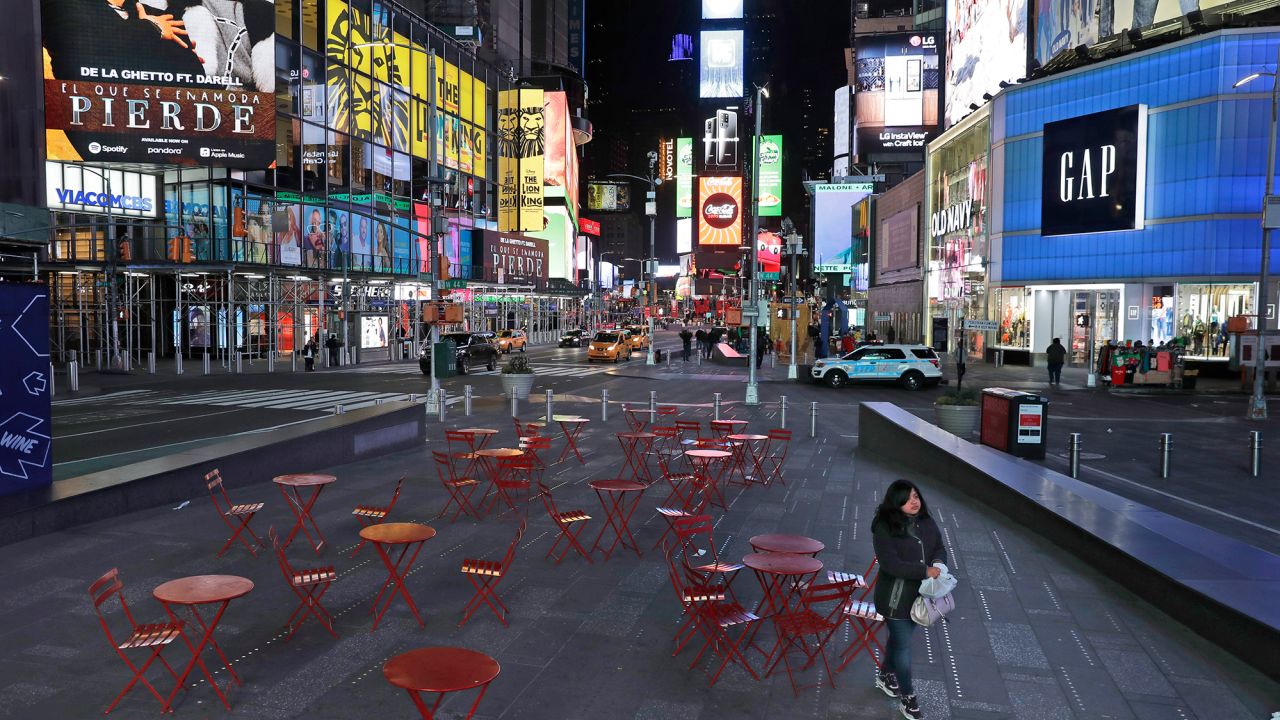 A woman walks through a lightly trafficked Times Square in New York, Monday.