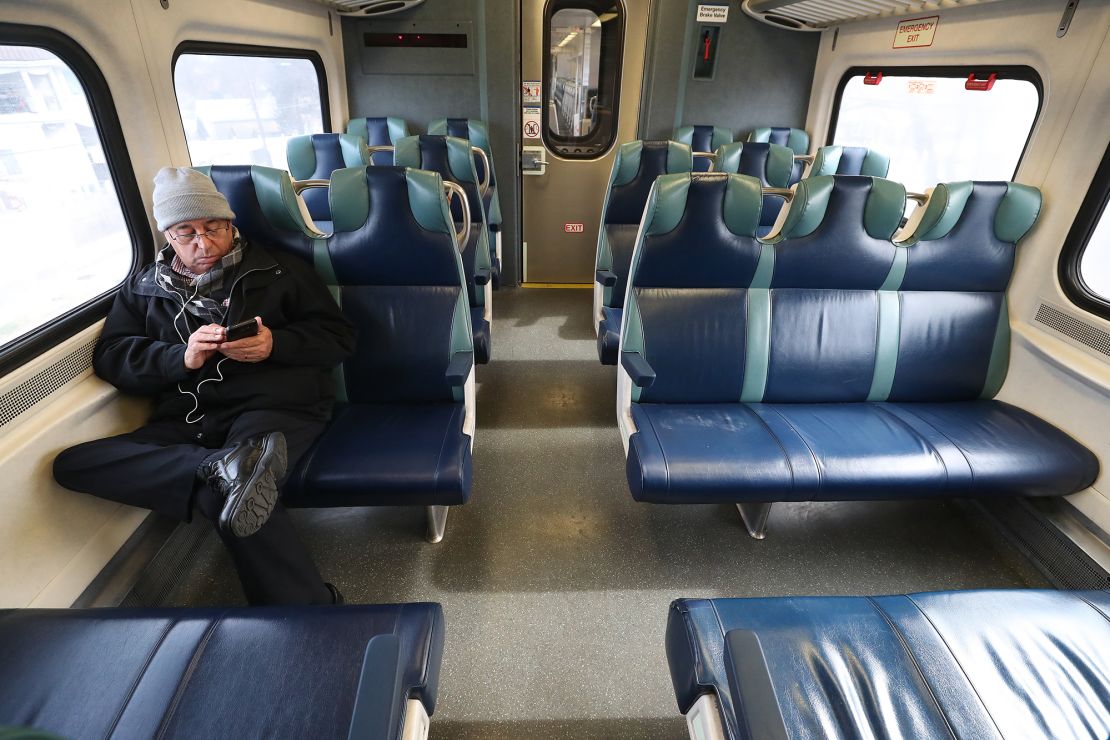  A man sits in an empty car while riding the Long Island Railroad.