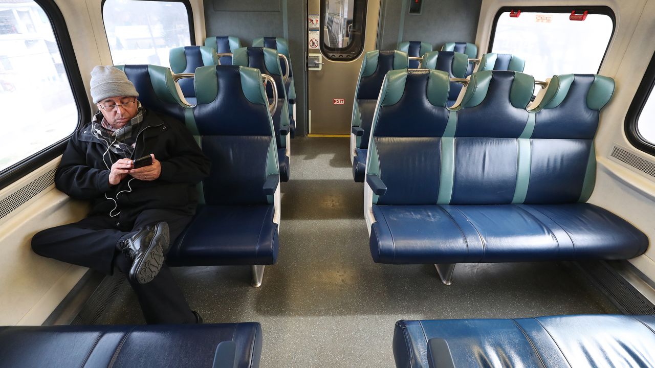  A man sits in an empty car while riding the Long Island Railroad.