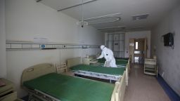 A worker disinfects a room at the Red Cross hospital in Wuhan, in China's central Hubei province on March 18, 2020. - The hospital, which has been used to treat COVID-19 coronavirus patients, will be temporarily closed from March 18 for a week of extensive disinfection, before being returned to service as a general hospital. (Photo by STR / AFP) / China OUT (Photo by STR/AFP via Getty Images)