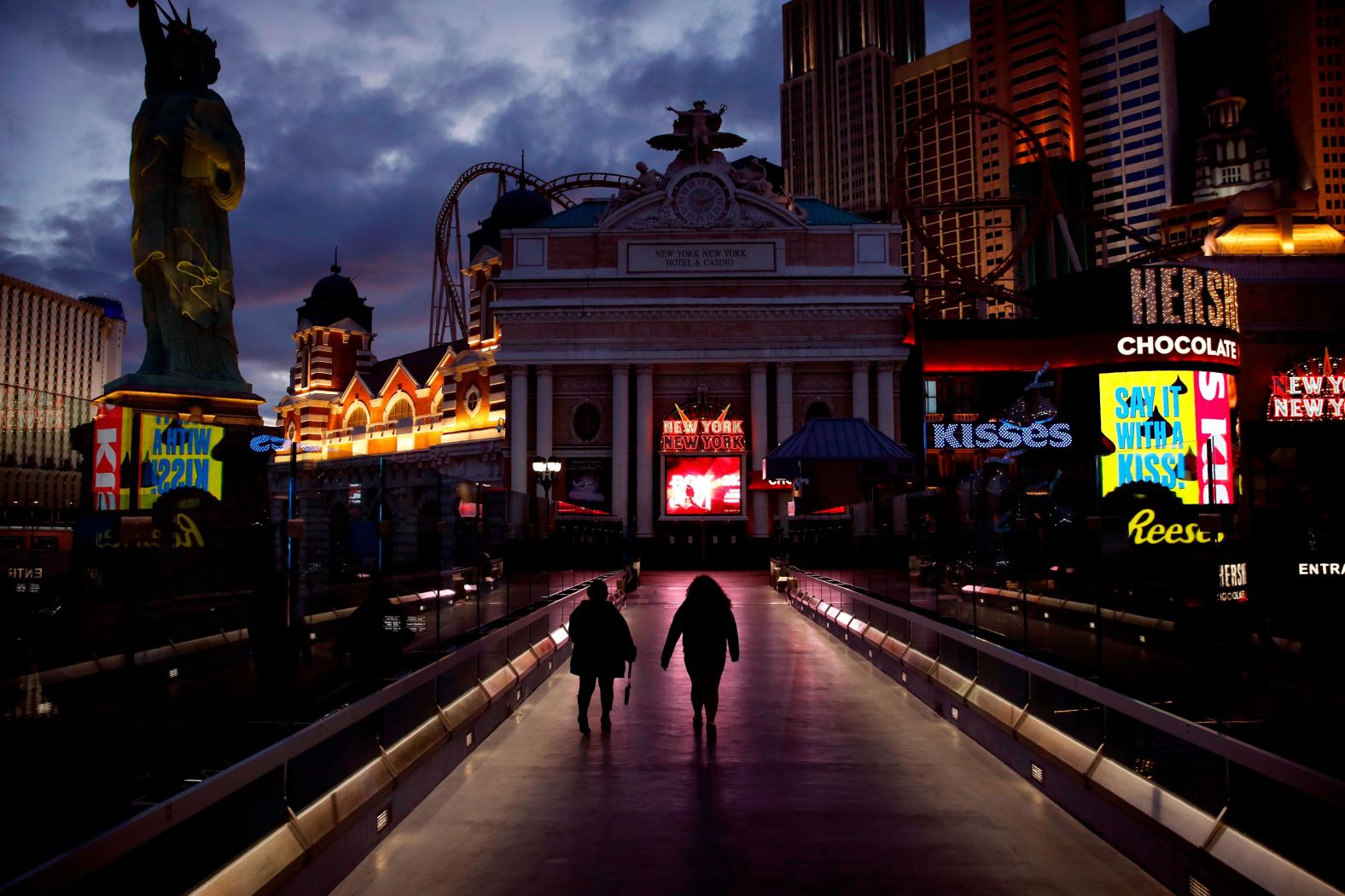 People walk along the Las Vegas Strip on March 18 after casinos were ordered to shut down.