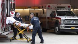 FDNY paramedics place an empty collapsible wheeled stretcher into an ambulance after delivering a patient into the emergency room at NewYork-Presbyterian Lower Manhattan Hospital, Wednesday, March 18, 2020, in New York. "Do not go to the emergency room unless it is a true, immediate and urgent emergency," said Mayor Bill de Blasio, who pleaded Tuesday with people who suspect they have coronavirus symptoms to stay home and see if they improve in a few days before even calling a doctor. For most people, the new coronavirus causes only mild or moderate symptoms. For some it can cause more severe illness. (AP Photo/Mary Altaffer)