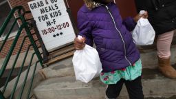 STAMFORD,  - MARCH 17: A student carries home bagged meals given out as part of Stamford Public Schools' "Grab and Go Meals for Kids" program, which is part of the city's response to the coronavirus pandemic on March 17, 2020 in Stamford, Connecticut. Since public schools in Stamford closed last week to help slow the spread of COVID-19, the city is offering two bagged meals per child each day. Many low-income families count on school meals to feed their children.. (Photo by John Moore/Getty Images)