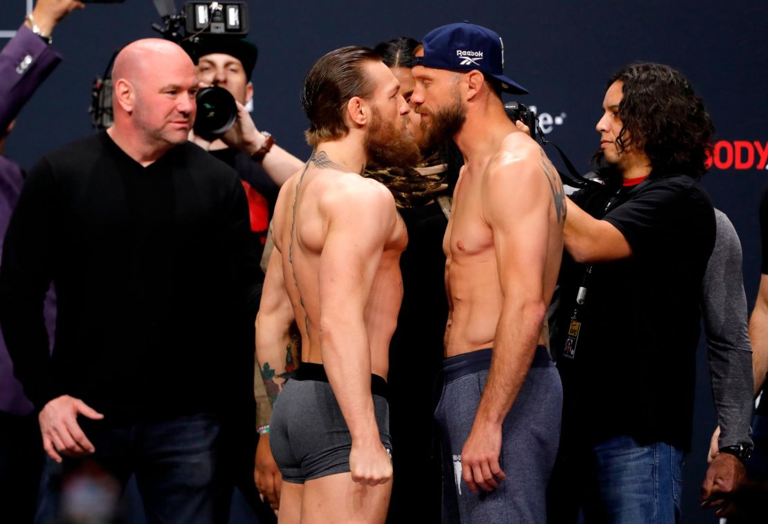 White looks on as  Conor McGregor and Donald Cerrone face off. 