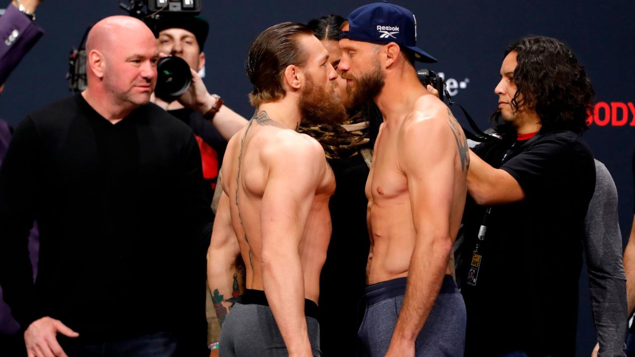 White looks on as Conor McGregor and Donald Cerrone face off.