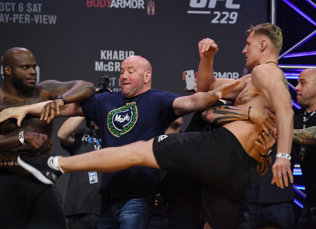 White gets in between Derrick Lewis (left) and Alexander Volkov (right).