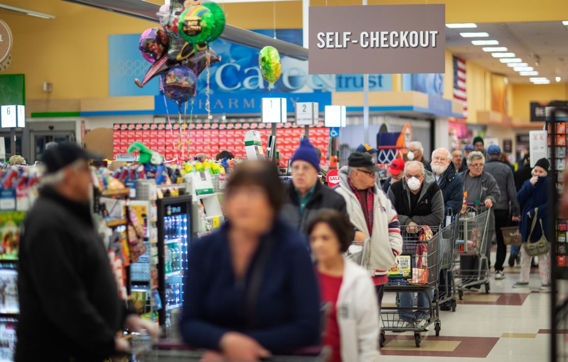 Shoppers wait in the checkout line at a Stop & Shop supermarket on Thursday, March 19, 2020, in North Providence, Rhode Island. 