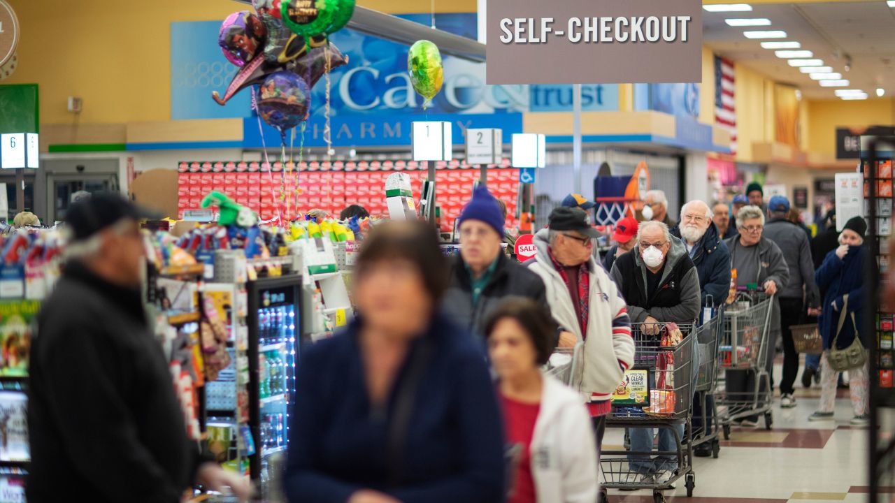 Shoppers wait in the checkout line at a Stop & Shop supermarket on Thursday, March 19, 2020, in North Providence, Rhode Island. 