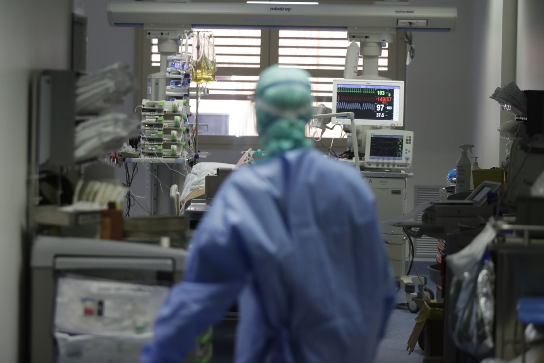 A doctor watches a coronavirus patient in the intensive care unit of Brescia hospital, Italy.