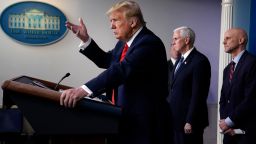 President Donald Trump speaks during press briefing with the coronavirus task force, at the White House, Thursday, March 19, 2020, in Washington. Food and Drug Administration Commissioner Dr. Stephen Hahn, right,†and Vice President Mike Pence listen. (AP Photo/Evan Vucci)