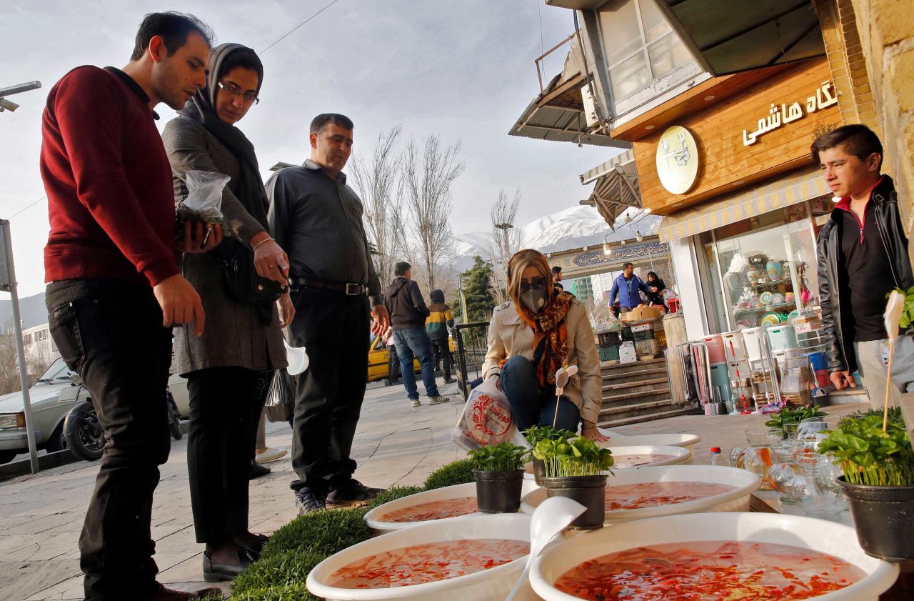 People view items for sale ahead of Nowruz outside the Tajrish Bazaar in Iran's capital Tehran on March 12, 2020.