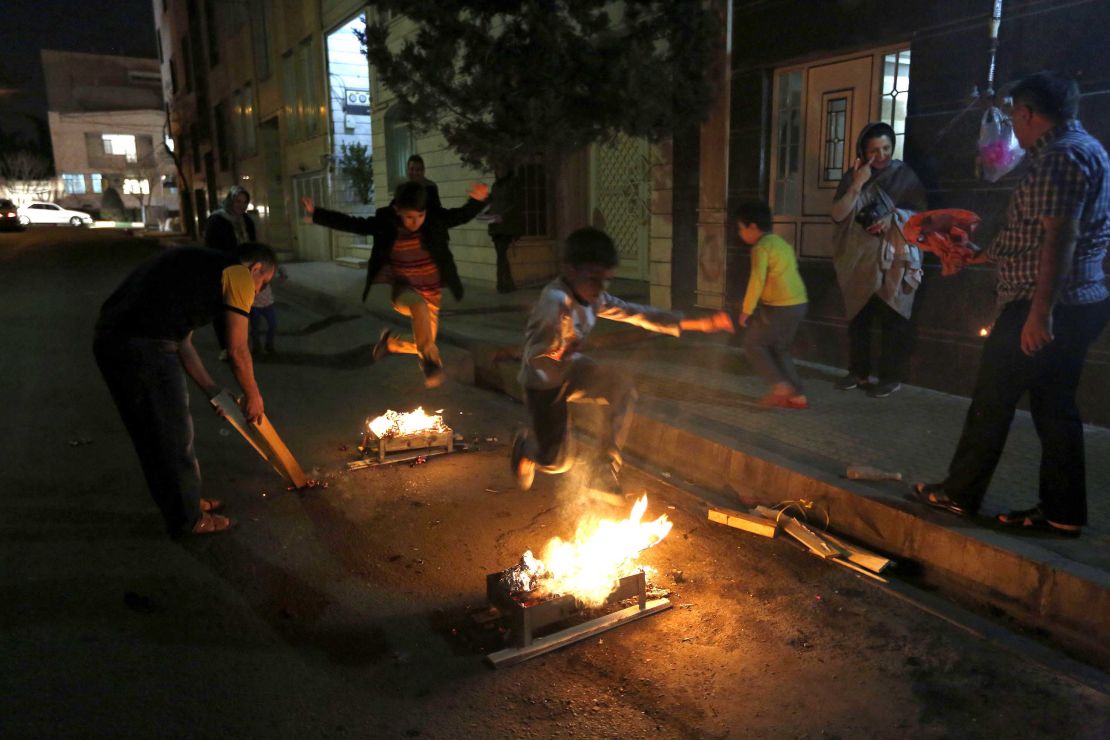 Iranians typically jump over bonfires to ward away sickness before Nowruz. This year, as traditions are transformed by the coronavirus, many have resorted to jumping over candles in their houses. 