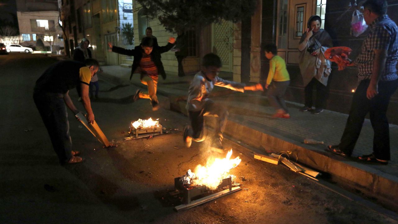 Iranian families light fire outside their houses in Tehran on March 13, 2018 during Chaharshanbe Soori.