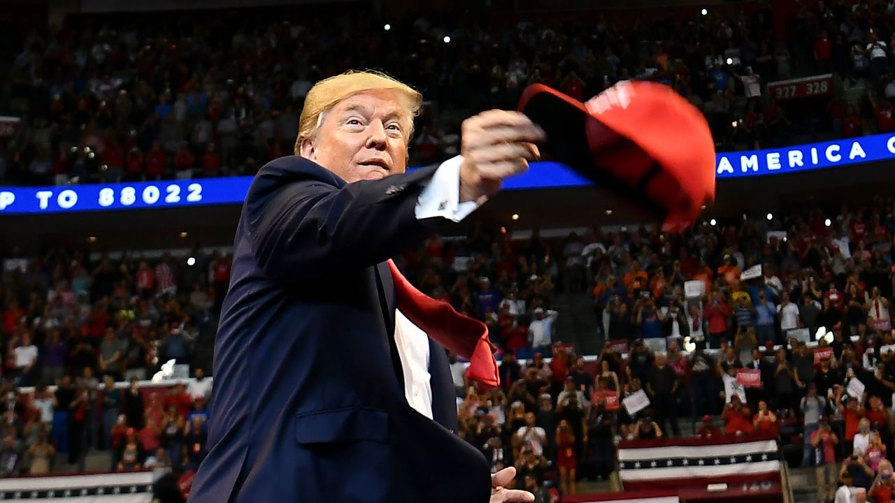 US President Donald Trump throughs MAGA caps to supporters as he arrives for a "Keep America Great" campaign rally at the BB&T Center in Sunrise, Florida on November 26, 2019. (Photo by MANDEL NGAN / AFP) (Photo by MANDEL NGAN/AFP via Getty Images)