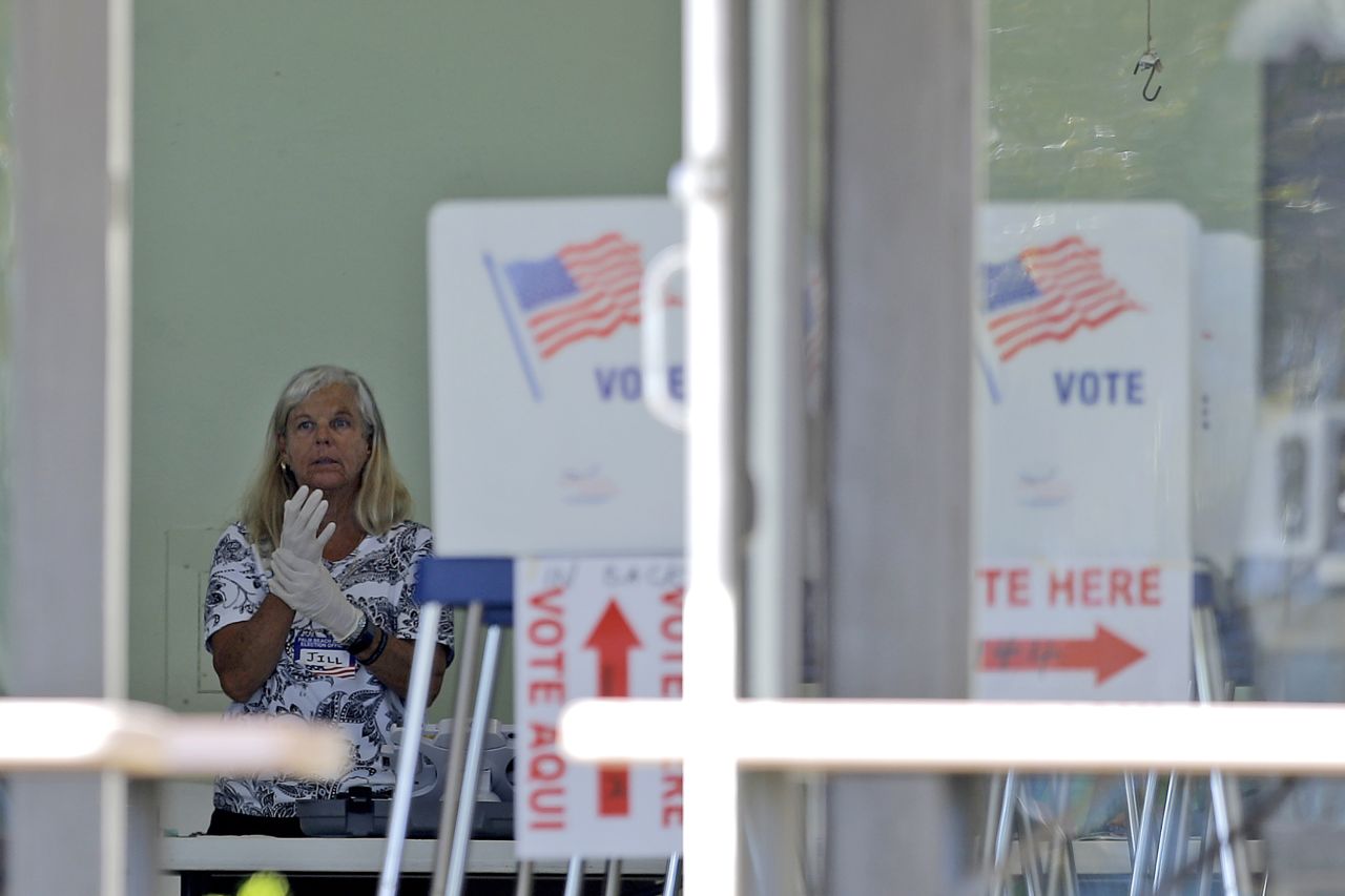 A polling place worker adjusts her gloves in Jupiter, Florida, on Tuesday, March 17. Voters in Arizona, Florida and Illinois <a href="http://www.cnn.com/2020/03/17/politics/gallery/primary-elections-0317/index.html" target="_blank">went to the polls Tuesday</a> despite the coronavirus pandemic that has put much of the world on hold.